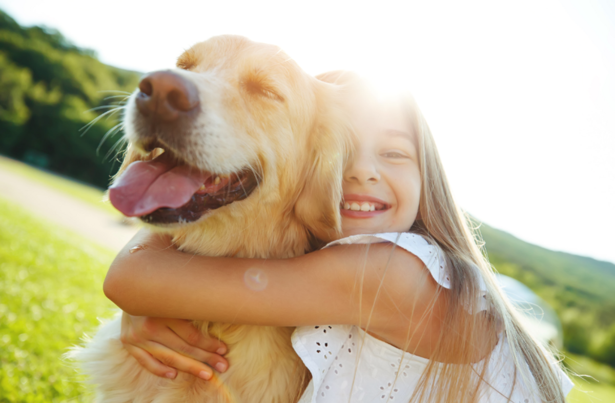 Girl hugging her dog at Longmeadow Animal Hospital